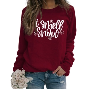 Detail of burgundy crewneck sweatshirt with white i smell SNOW text and snowflakes