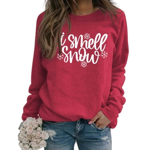 Detail of red crewneck sweatshirt featuring white I smell Snow slogan and snowflakes