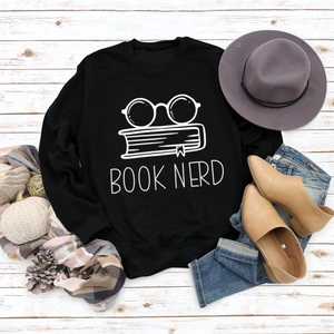 Flat lay of black Book Nerd sweatshirt paired with casual autumn style accessories