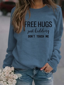 Detailed close-up of blue crewneck sweatshirt with Free Hugs humorous print