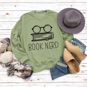 Detail of Book Nerd print on green crewneck sweatshirt with glasses and books