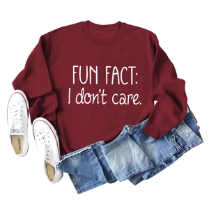 Flat lay of maroon crew neck sweatshirt featuring Fun Fact I Don't Care lettering