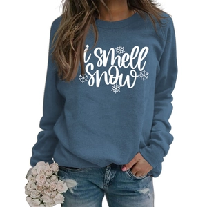 Detail of blue crewneck sweatshirt with 'i smell snow' white print and snowflake pattern