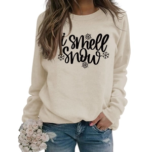 Detail of cream sweatshirt with 'i smell snow' lettering and snowflake print