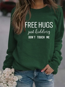 Detail of Free Hugs slogan print on dark green long sleeve crewneck sweatshirt for women
