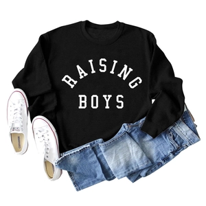 Flat lay of Raising Boys oversized black sweatshirt with white lettering and denim jeans