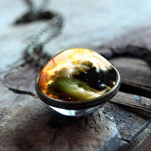 Cosmos nebula glass ball pendant necklace with double-sided galaxy design on wood