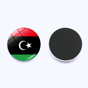 Macro view of round glass magnet showing Libya flag design and black magnetic base