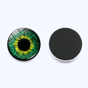 Green and yellow cat eye glass magnetic fridge magnets on white background