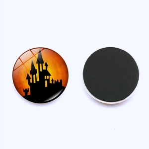 Detail of Halloween fridge magnet featuring spooky castle silhouette on glass dome with magnetic back
