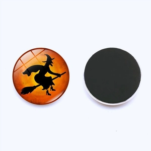 Detail of Halloween glass magnet showing witch silhouette and the round black magnetic backing