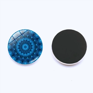 Detailed view showing both sides of a 30mm glass mandala yoga fridge magnet with magnetic back
