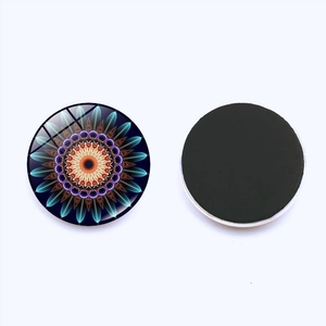 Detail of round Mandala crystal glass fridge magnet showing front pattern and back magnetic pad