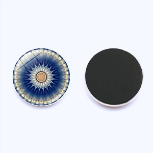 Macro view of crystal glass mandala fridge magnet showing front pattern and back magnetic side