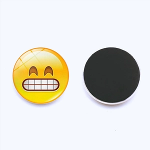 Detail of 25mm round emoji glass fridge magnets showing glossy surface and magnetic back