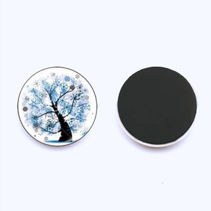 Detail of 25mm Tree of Life glass fridge magnet with winter snowflake pattern and magnetic back