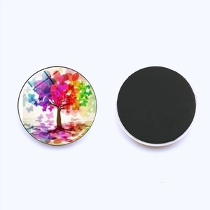 Macro view of 25mm Tree of Life glass fridge magnet with colorful butterfly leaf pattern