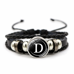 Detailed view of multilayer woven leather bracelet with metal beads and letter D charm