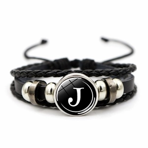 Detail of multi-layer leather bracelet with letter J glass cabochon and silver beads