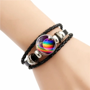 Braided leather galaxy bracelet featuring a colorful planet glass cabochon charm