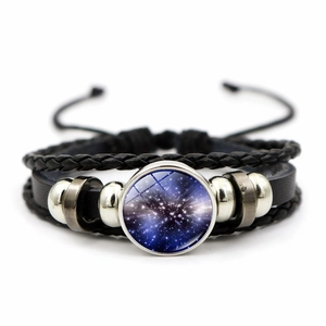 Detailed view of multilayer leather bracelet with a cosmic nebula galaxy glass charm