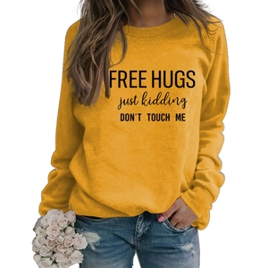 Detail of Free Hugs slogan print on long sleeve yellow cotton sweatshirt for women