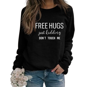 Black long sleeve sweatshirt with Free Hugs print paired with distressed denim jeans