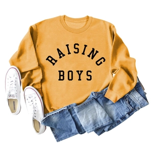 Detail of Raising Boys letter print on mustard yellow long sleeve sweatshirt fabric