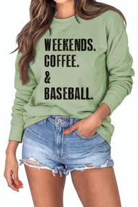Detail of the oversized green cotton sweatshirt featuring black typography and ribbed cuffs