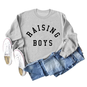 Flat lay of a grey crew neck sweatshirt featuring Raising Boys text with casual jeans