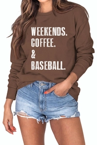 Detail of white slogan print on brown crewneck sweatshirt with distressed denim shorts
