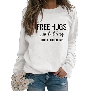 Detail of Free Hugs slogan print on a white long sleeve crewneck sweatshirt for women