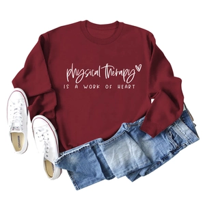 Flat lay of burgundy crewneck sweatshirt with physical therapy text and blue jeans