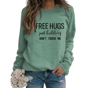 Detail of grey-green long sleeve sweatshirt with humor text and soft cotton texture