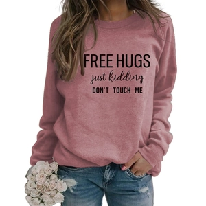 Detail of pink long sleeve sweatshirt with FREE HUGS just kidding text print
