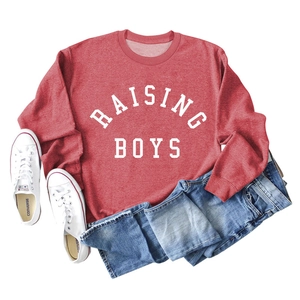 Flat lay of heather red RAISING BOYS sweatshirt with blue jeans and white sneakers