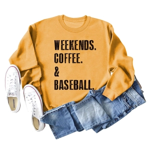 Close-up of mustard yellow sweatshirt with Weekends Coffee & Baseball slogan print