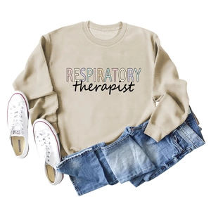 Detail of loose beige sweatshirt featuring colorful Respiratory Therapist text and jeans