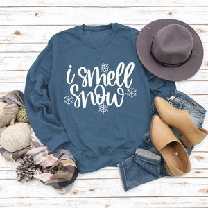 Navy blue crewneck sweatshirt with 'I smell Snow' text and snowflake graphic print