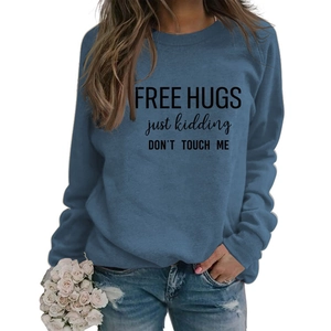Detail of Free Hugs slogan print on long sleeve navy blue sweatshirt with denim styling