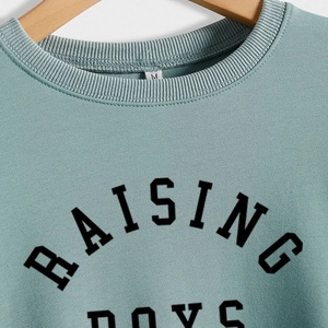 Mint green Raising Boys slogan sweatshirt for women in a comfortable loose fit style