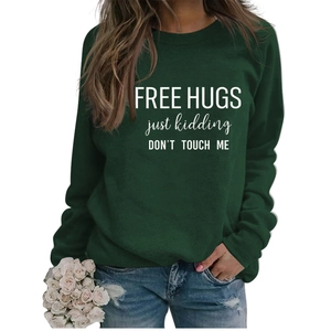 Close-up of white letter print on dark green long sleeve crewneck sweatshirt for women