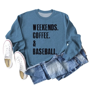 Close-up of Weekends Coffee Baseball text print on blue long sleeve cotton sweatshirt