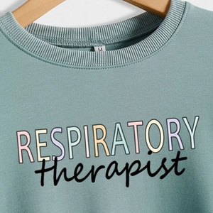Sage green respiratory therapist sweatshirt with colorful letter print on front