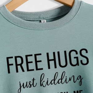 Sage green Free Hugs Just Kidding sweatshirt with ribbed crew neck and soft cotton fabric