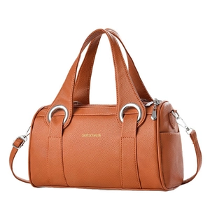 Caramel brown pebbled leather Boston pillow handbag with top handles and shoulder strap