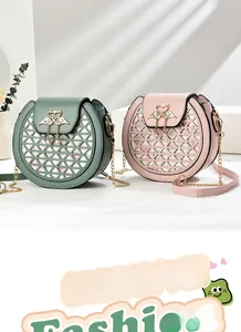 Detail of hollow triangle pattern and heart swan metal buckle on stylish shoulder bags