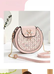 Detail of pink round crossbody bag with geometric cut-out and pearl swan charm