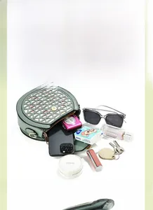 Green PU leather mini crossbody bag interior showing storage space for phone and makeup
