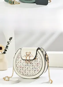 Detail of off-white crossbody bag with hollow patterns and swan metal lock